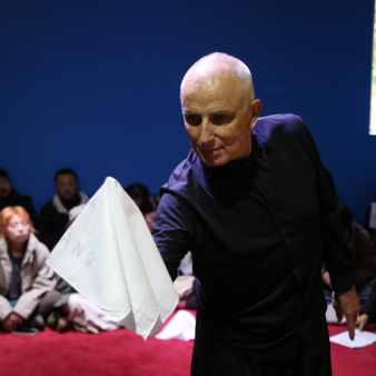 Showing white handkerchiefs with XIWANG / HOPE around to the people present. THE GIFT [HIGHER GOALS] FIRST VERSION.